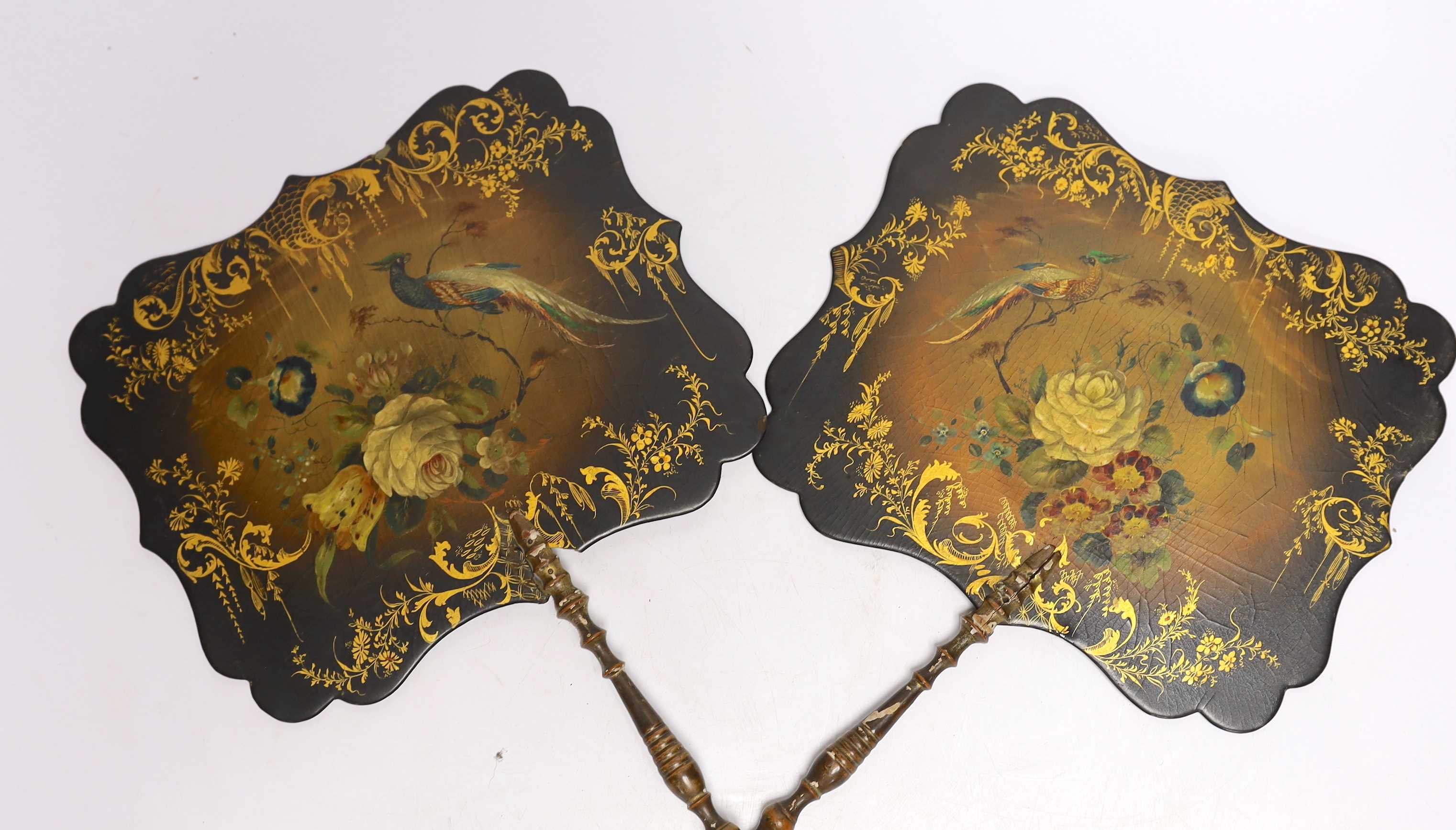 Two Regency papier mache face screens decorated with flowers and peacocks, 39cm high